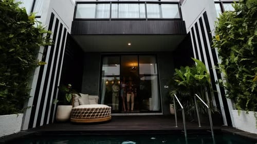 Married Couple Look Around Their New House Real Estate Agent Opening the Door