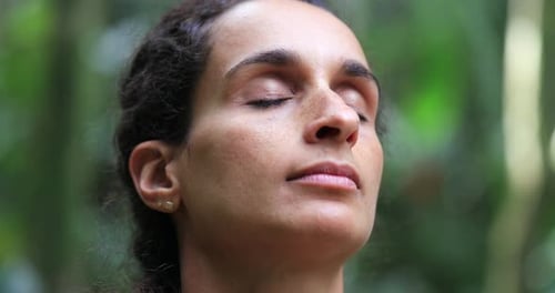 Woman Meditating Peacefully in Natural Green Setting