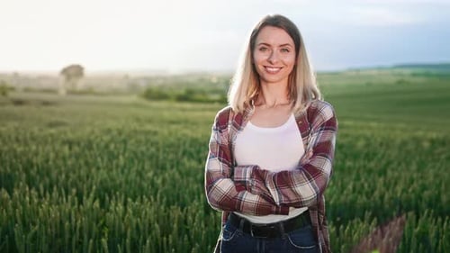 Seductive Blonde Lady Standing on Field Looking at Camera Smiling
