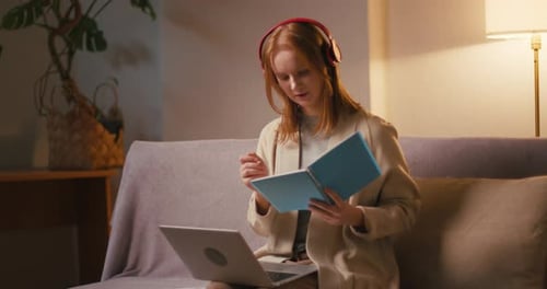 Woman Studying with Laptop and Notebook at Home