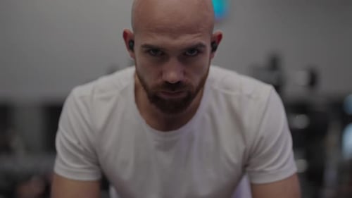 Focused Athlete Prepares for Intense Workout in Gym