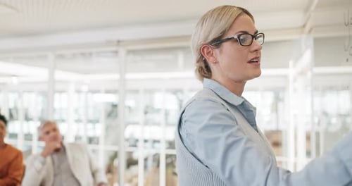 Woman Giving a Presentation to Colleagues