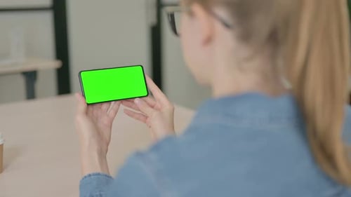 Rear View of Young Woman Holding Smartphone with Chroma Key