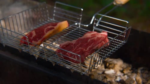 Close-up of hot juicy red meat on grill