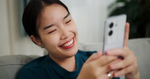 Smiling Woman Video Calling on Phone at Home
