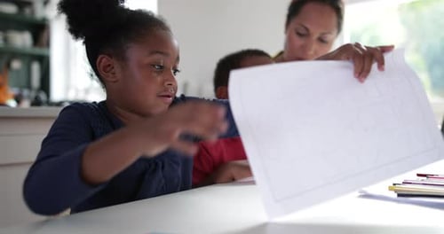 African American holding up school work proudly