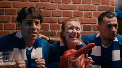 Friends Cheering While Watching a Sports Game