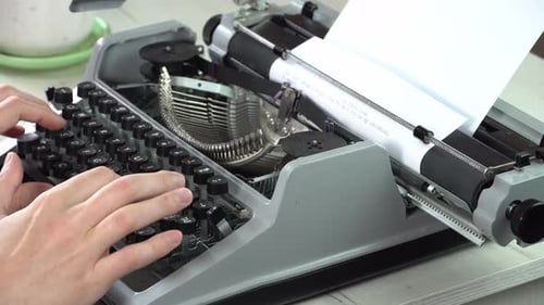 Writing a book and typing old typewriter, top view. Man typing on old vintage retro typewriter