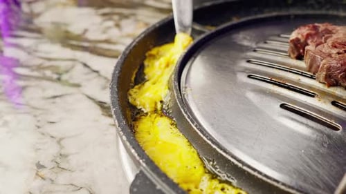 close up of delicious appetizing juicy piece grilled cheese being fried in korean restaurant