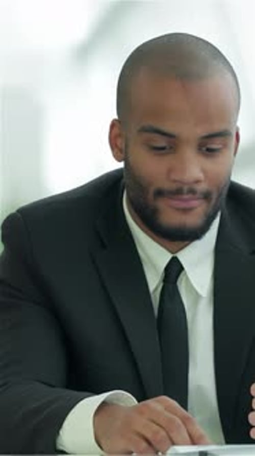 Young Adults Discussing Business on Tablet in Office