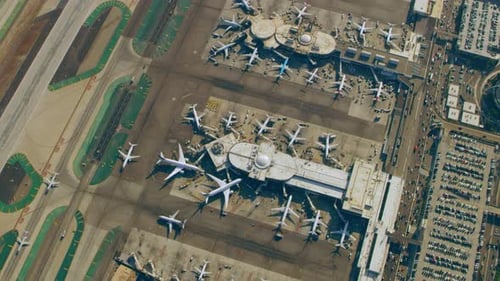 Airplanes wait on lax runway ready for takeoff on a sunny Los Angeles day
