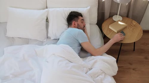 Man Wakes Up and Reaches for his Phone