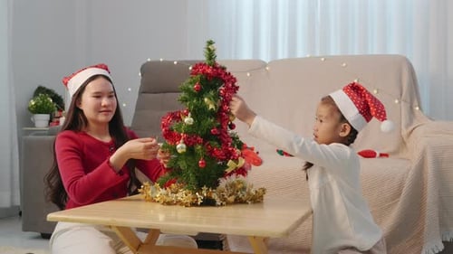 Girls Decorating Christmas Tree in Bright Home Interior