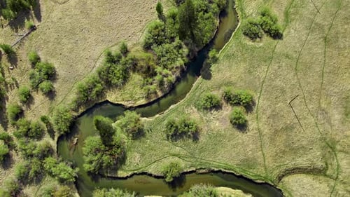 Aerial Of A Winding River Through A Meadow