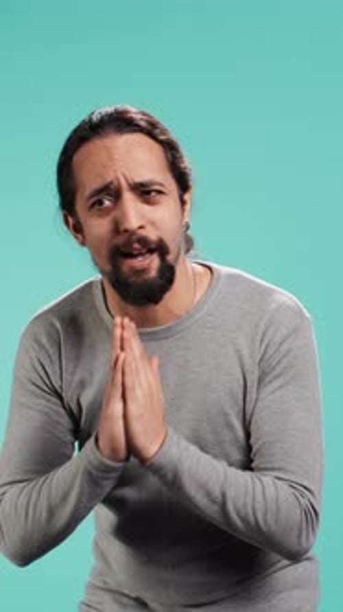 Adult Man Pleading with Hands Together