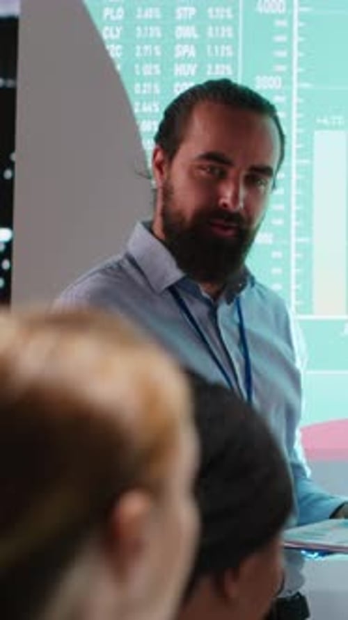 Vertical Video Business Partners Examining Annual Sales Reports in Corporate Meeting