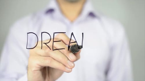 Man Writing the Word Dream with Marker