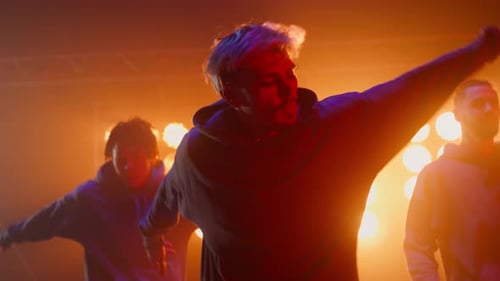 Three Stylish Hiphop Guys Dancing Synchronously on Stage Nightclub Close Up. Professional