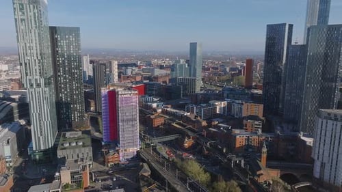 Aerial View of Manchester Cityscape with Skyscrapers and Train Tracks