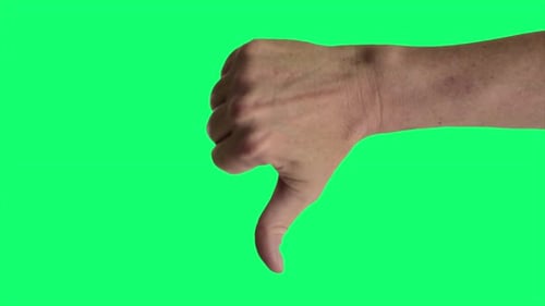 Close up shot of a male hand giving a classic thumbs down sign, against a greenscreen background ide