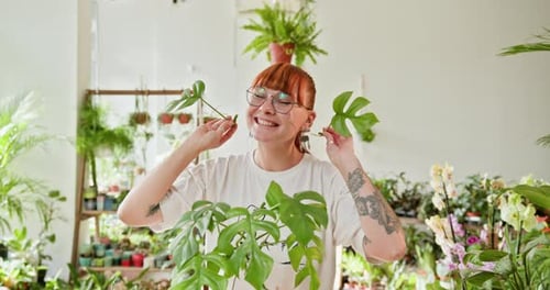 Playful Woman With Plants in Bright Home Garden