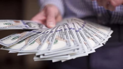 Counting a Stack of United States Currency