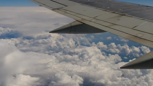 View of Jet Plane Wing Over the Clouds