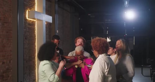 Group Surrounds Adult in Possible Prayer Meeting