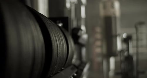 Weight Plates in Modern Gym Near Air Bike and Punching Bag