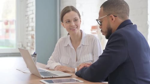 Business Meeting at Desk with Laptop in Office
