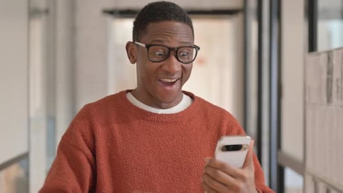 Excited Man Celebrates Using Mobile Device