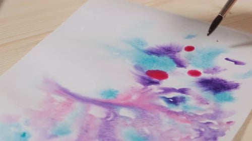 Watercolor Painting with Brush on White Paper