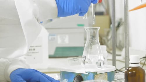 Scientist Conducting Chemical Experiment in Laboratory