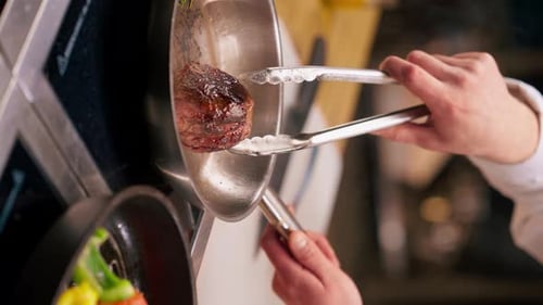 Chef Cooking Meat in Professional Kitchen