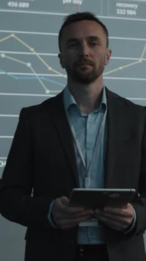 Professional Man with Tablet Presenting Data Analysis