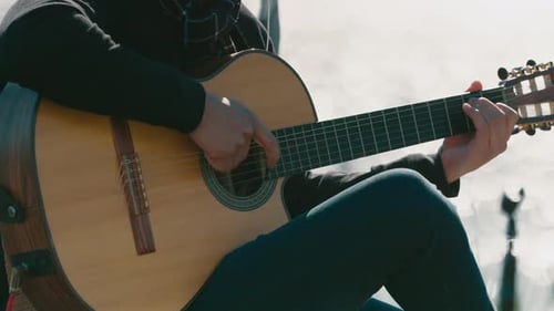 Close-up of musician playing acoustic guitar in Argentine folk music performance
