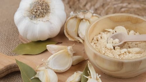 Garlic Bulbs, Cloves, and Powder on Wood