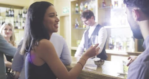 Love, man and woman toast in a club with drinks or alcohol in celebration of new years