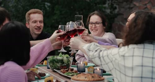 Friends Toasting with Wine at Urban Dinner Party