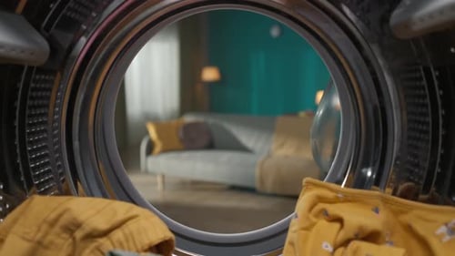 View From Inside the Washing Machine Full of Colorful Clothes Inside and Opened Door