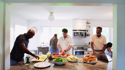 Friends and Family Prep Food Together in Kitchen
