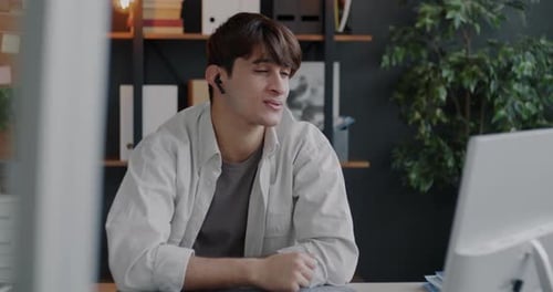 Young Adult at Desk Having Video Conference