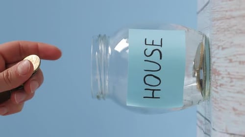 Saving Coins in Jar for Future Home Purchase