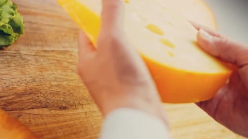 Hands Rotate Piece of Swiss Cheese Close Up