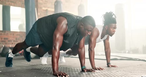 Black man, fitness and mountain climber exercise at gym on floor for workout or training together