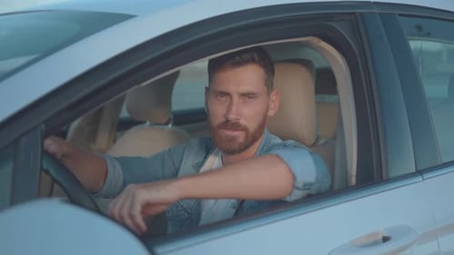 Handsome Man Sitting Inside Car Smiling