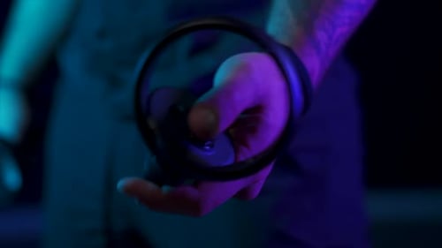 Hand Using VR Controller in Dark, Futuristic Setting