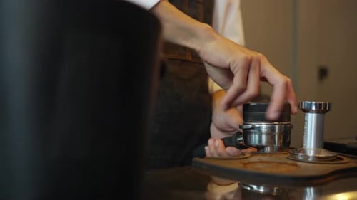 4K Barista making hot coffee on coffee maker at coffee shop.