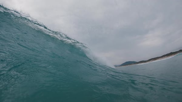 Ocean wave breaks on the shore. Wave rolls and breaks over the coastal ...