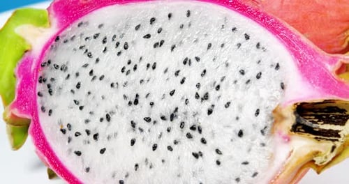 Close Up White Dragon Fruit Pulp Rotation Shot. Pitahaya Sliced Pieces Background